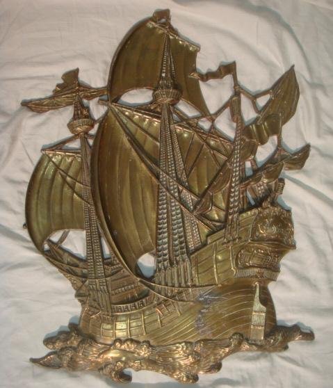 Brass Spanish Galleon Wall Plaque:: Brass Spanish Galleon Wall Plaque: Ca. 1950's Intricately Cast Triple Masted Ship. Its Flags and Sails Waving in The Wind, and Waves Crashing Against the Hull While the Dolphins try to Out Race it. 27