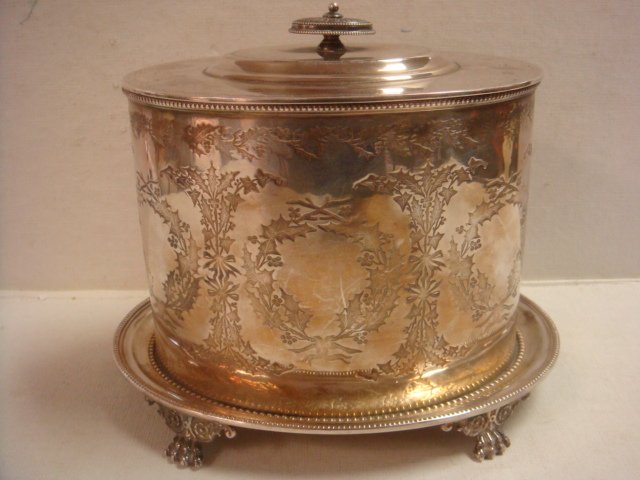 Victorian Silver Plate Biscuit Box, Ca 1870:: Victorian Silver Plate Biscuit Box, Ca 1870: Oval Box with Embossed Holly Pattern and Beaded Rim. Hinged Lid. Applied to Beaded Rim Tray with 4 Paw Feet. Provenance from Antique Silver Collection of J