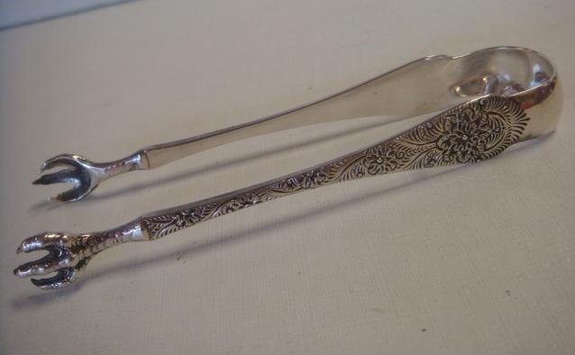 TIFFANY & CO Sterling Claw Tongs:: TIFFANY & CO Sterling Claw Tongs: Chased Vines and Floral Decoration, Designed in 1890. 6 1/4"L. Stamped in Handle M- Tiffany & Co Sterling. 2.82 OZ. (150-250)