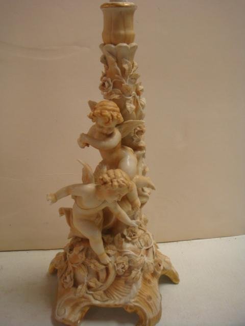 Pair of Late 19th Century SITZENDORF Candlesticks:: Pair of Late 19th Century SITZENDORF Candlesticks: Each has a Pair of Cherubs with Rose Vines on Spreading Scroll Bases. One on Each Holds a Bell. 13 1/4"T. Blue Crossed Lines Mark and Impressed 343.