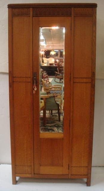 ARTS & CRAFTS Golden Oak Armoire with Mirror:: ARTS & CRAFTS Golden Oak Armoire with Mirror: Flat Cornice over Single Door, Flanked by Panels having Carving Mid-way on Front. Cabinet Door inset with Beveled Mirror. Open Interior with Rod for Hangi