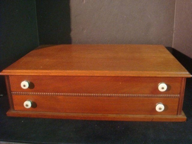 Two Drawer Mahogany Spool Cabinet:: Two Drawer Mahogany Spool Cabinet: Cabinet has Beveled Top. Beaded Edge Between 2 Narrow Drawers. Porcelain Knobs. 6"T, 21 3/4"W, 14"D. (100-200)