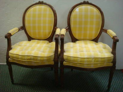 Pair of Antique French Style Open Arm Chairs:: Pair of Antique French Style Open Arm Chairs: Closed Balloon Back in Finger Molded Frame. Floral Carving at Center of Crest Rail. Carving on Hand Rests and Arm Supports. Round Tapered Fluted Legs