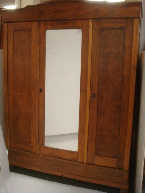 Vintage Rustic Pine Triple Breakdown Wardrobe:: Vintage Rustic Pine Triple Breakdown Wardrobe: Molded Top Over Triple Doors. Center Door Has Inset Beveled Mirror, Center & Right Doors Have Key Locks. Interior Includes Hanging Bar. Supported On Bun