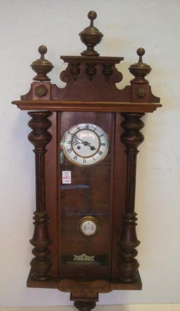 German Walnut Cased Wall Clock:: German Walnut Cased Wall Clock: Half Turned Columns Affixed to Glass Front Door & Brass Knob. Enameled Face w/Brass Roman Numerals. R/A On Pendulum, Commonly Used In France For Retard and Advance. Ove