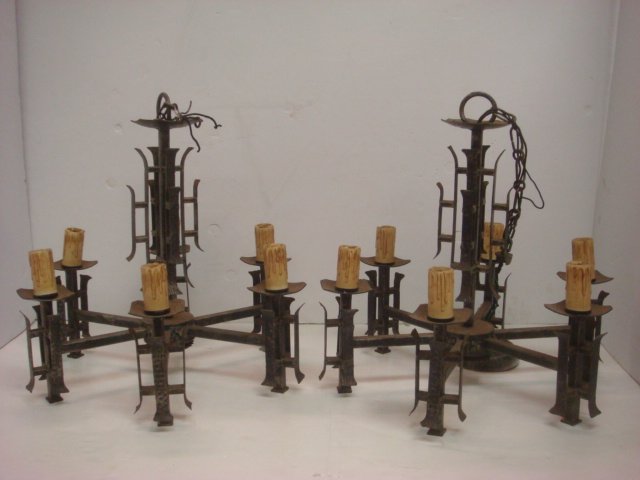 Pair of 5 Arm Bronze Arts and Crafts Chandeliers:: Pair of 5 Arm Bronze Arts and Crafts Chandeliers: Open Frame Body, Center Ring with Rosettes Supports 5 Straight Spoked Arms. Gothic Character. Metal Hammered Bands Support Squared Bobeches with Patte