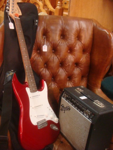 FENDER Stratocaster Squire Electric Guitar and Amp:: FENDER Stratocaster Squire Electric Guitar and Amp: Serial Number Ic 041009816; Six String, Maple Neck with Candy Apple Red Body, White Pickguard and Strap. Ca. 1980's, Made in Indonesia. Also Has Sof