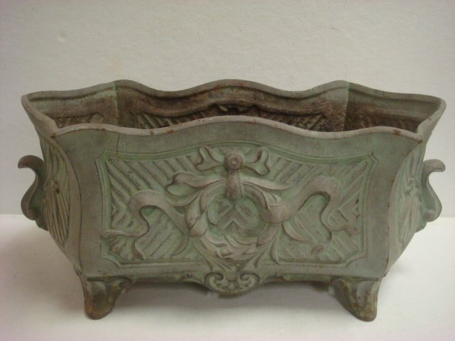 Cast Iron Verdigris Garden Planter:: Cast Iron Verdigris Garden Planter: Irregular Rectangular Shape with Raised Wreath and Ribbon Decorated Sides. S-Scroll Handles. Raised on Scooped Feet. 16"W, 8"T. C. 1920. (80-140)