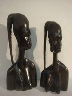 Two Carved EBONY African BENIN Tribal Female Busts:: Two Carved EBONY African BENIN Tribal Female Busts: Dark Polished Smooth Ebony Wood Busts Representing the Ideal Form of Beauty. Hair is Upswept and Braided (one is broken) in Traditional Style. 12