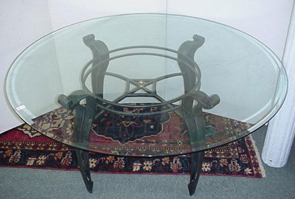 Round Glass and Wrought Iron Dining Table: Round Glass and Wrought Iron Dining Table: Circular 1/2" Glass Top Table is 60" Diameter. Base is Gray/Black Wrought Iron with X Stretcher Under Double Ring Support.