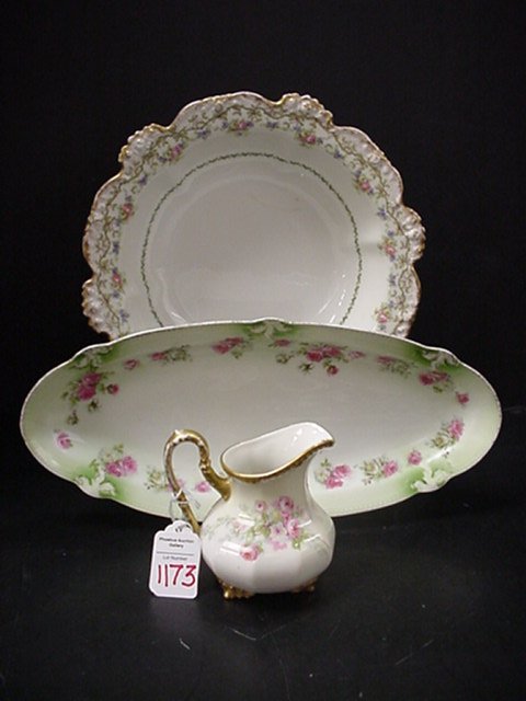 3 Vintage Floral Porcelain Pieces: 3 Vintage Floral Porcelain Pieces: 4" Limoges Elite Creamer, 13" German Oval Celery Tray and 10" JP French Center Bowl. One Hairline and Minor Gold Rubbing.