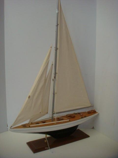 Wooden Model of Racing Sloop: #1: Wooden Model of Racing Sloop: #1 Brass Deck Fixtures, Full Sails, Spinnaker Poles on Fore Deck 35" x 24" x 5". Brass and Wood Display Stand. (150-500)