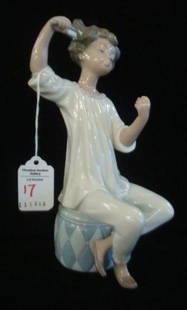 LLADRO Figurine, "Girl Brushing Hair:: LLADRO Figurine, "Girl Brushing Hair: Designed in 1969 by Vicente Martinez. 8 3/4"T, Seated on Hassock, Retired in 1985, #1081. No Vanity Mirror. (50-100)