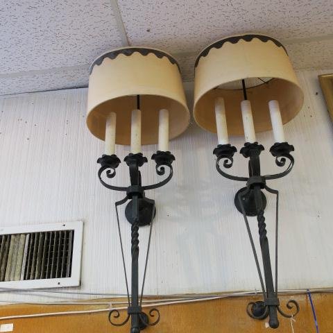 Pair of Mid Century Wrought Iron Electric Wall Sconces:: Pair of Mid Century Wrought Iron Electric Wall Sconces: Spanish Revival Torch Style with 3 Candle Lights in Fluted Bobeches Supported by Coiled Arms. Two Metal Back Plates Project from Wall. Rope Twis
