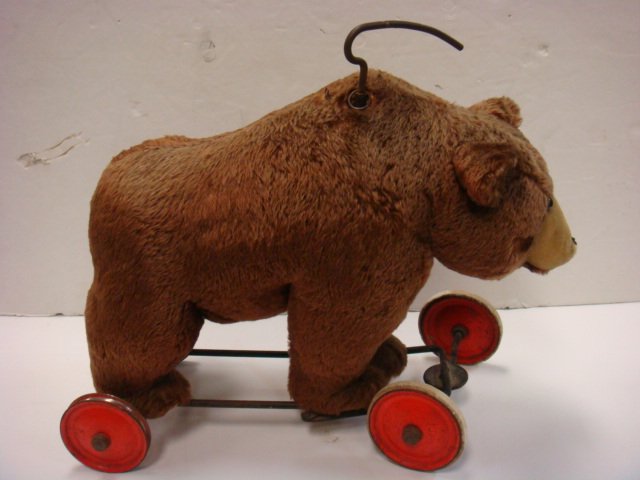 Mohair STEIFF Riding Bear with Working Growler:: Mohair STEIFF Riding Bear with Working Growler: Standing Brown Bear with Blonde Muzzle, Stitched Nose (Some Loss) and Glass Eyes. Steering Handle & Growler Pull on Shoulders. Red Wheels Have Some Wear