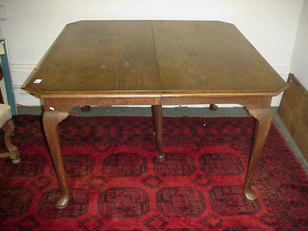 Walnut Dining Table with 2 Leaves: 502. Walnut Dining Table with 2 Leaves: 50" Square with 2 12" Leaves. Beveled and Canted Edge with Queen Anne Legs. For Detailed Condition Report Please Call 757 722-9210. Items are sold AS IS, no ref