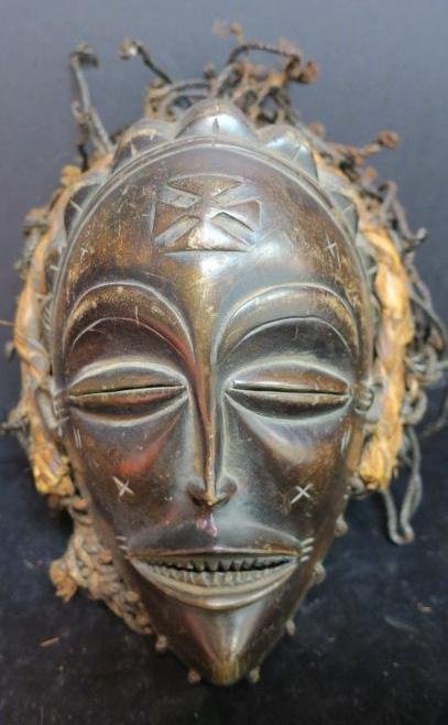 CHOKWE Tribe, Zaire, Happiness Ceremonial Mask:: CHOKWE Tribe, Zaire, Happiness Ceremonial Mask: CA 1900, Facial Scar Tattoo in Maltese Cross Form, Slit Bean Eyes and Pointed Filed Teeth. Twine Backing holds Mask in Place on Face. 14" x 7", African 