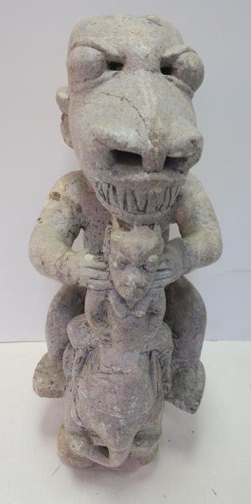 Stone Fetish Statue of Monster on Elephant:: Stone Fetish Statue of Monster on Elephant: Fanged Monster with Filed Teeth and Bulging Eyes Riding Elephant Holding Young Mahot In Arms. Tall. African Art Collection of Nick Beskenis. (200-300)