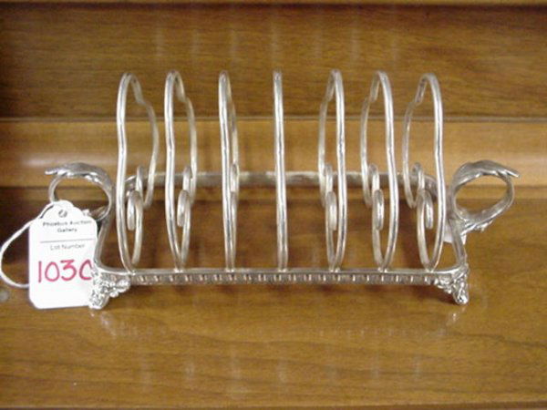 Reed and Barton Silver Soldered Toast Holder:: 1030. Reed and Barton Silver Soldered Toast Holder: 6 Slot Toast Holder is 8"L. 3 1/2"T. It has Leaf Topped Ring Handles on Each End. For a Detailed Condition Report call 1 757 722-9210. All Sales are
