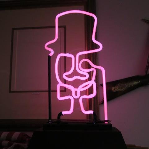 Pink Neon Sign of MR. ESQUIRE in Top Hat and Bowtie:: Pink Neon Sign of MR. ESQUIRE in Top Hat and Bowtie: 21" Tall. Complete with Monicle, Working Order. The Dapper Gent is Ready for your next Party Mix. (150-300)