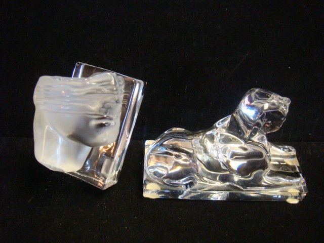 BACCARAT & DAUM Crystal Paperweights:: BACCARAT & DAUM Crystal Paperweights: Baccarat Clear Glass Sphinx Paperweight is 4 3/4" X 1 7/8" X 3 1/4"T. Igor Mitoraj for Daum Pate De Verre Fragmented Head on Clear Plinth, Ca 1983, is 1 3/4" X 3"
