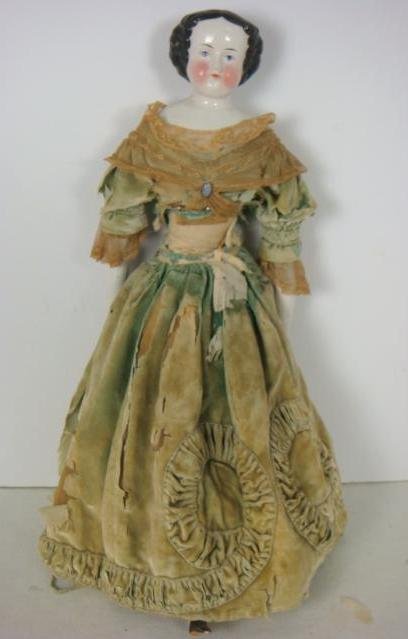 China Head Shoulder Plate Victorian Doll:: China Head Shoulder Plate Victorian Doll: Flat Head with High Brow, Painted Black Hair in Civil War Style and Blue Eyes. China Arms, Legs with Cloth Body. Original Clothing (Cloth Shattering). 22"T. (