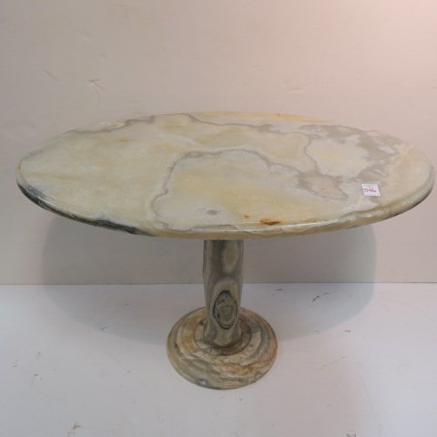 Oval Onyx Low Table:: Oval Onyx Low Table: Carved Top Over Baluster Shaped Pedestal on Round Carved Base. Shows Colors of Beige, Pale Green, Orange and Black. 19 3/4" X 30 1/2" X 19". Possibly 1970's. (150-300)