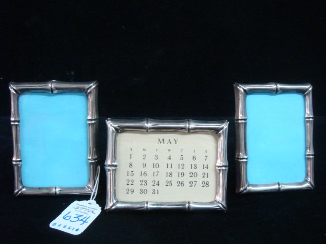 Three TIFFANY & CO Sterling Bamboo Picture Frames:: Three TIFFANY & CO Sterling Bamboo Picture Frames: One Horizontal with Calendar and Two Vertical. All are 3" X 4" with 2 1/4" X 3 1/4" Opening. Marked Tiffany & Co Makers on Stand. (300-400)