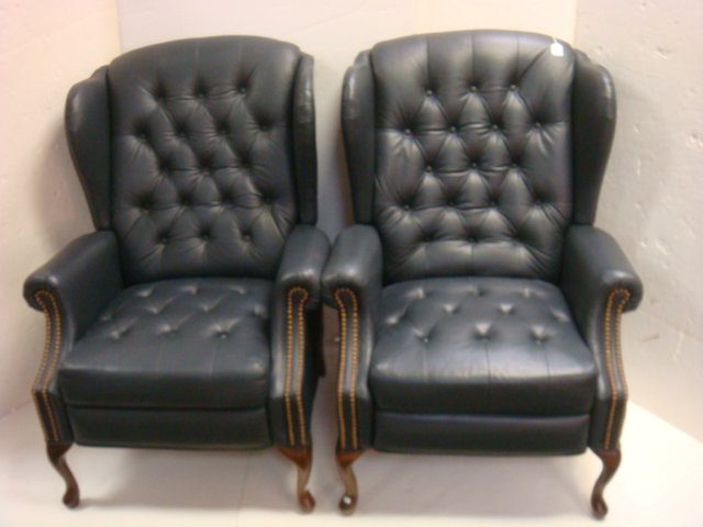 Pair of Leather Button Tufted Wing Back Recliners:: Pair of Leather Button Tufted Wing Back Recliners: Button Tufted Back and Seat with Metal Nailhead Trim Down Rolled Arms. Deep Side Wings. Supported on Cabriole Legs with Pad Feet. 42" to Back. Action
