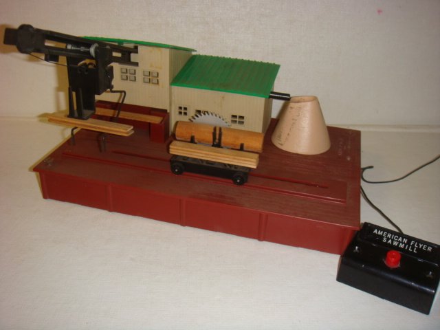 AMERICAN FLYER, "Remote Control Sawmill", #23796:: AMERICAN FLYER, "Remote Control Sawmill", #23796: CA 1957, Saw Mill Train Accessory. Whirling Blade "Cuts" Log and Makes Boards, Lumberjack Loads into Mill or on Gondola Car. 5 Boards Included. 11" x