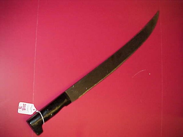 Machete with Black Plastic Handle: 208B. Machete with Black Plastic HandleThe Classic Field Clearing Weapon Ready to Dispose of any Cane Snake. 26" long with a 21' Blade. Very Good Condition. Buyers are reminded that items in the aucti