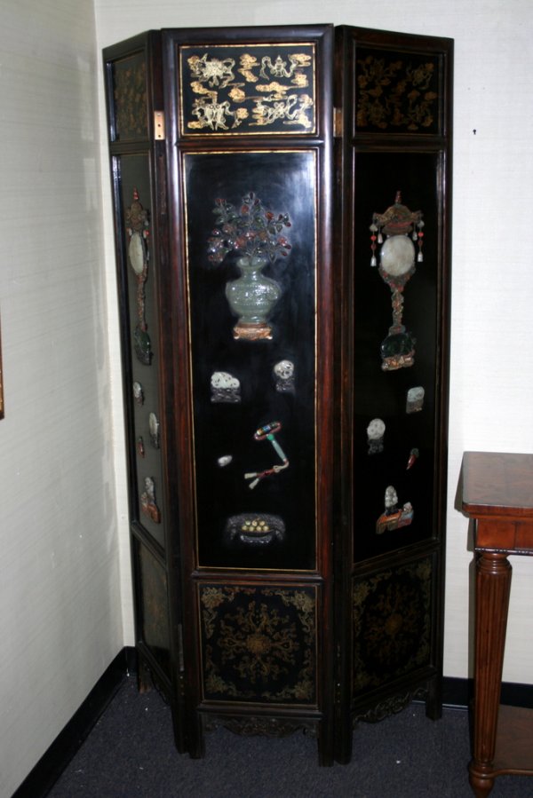 A very good six panel Chinese black lacquer floor: A very good six panel Chinese black lacquer floor screen with extensive carved hardstone inlays. Border panels with relief carved floral motives. Each panel 15 1/4" wide, 73" high.