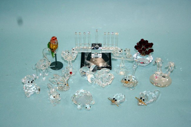 SWAROVSKI- A lot of 15 miniature crystal figurines o: SWAROVSKI- A lot of 15 miniature crystal figurines of various large and small animals, including a colourful parrot on a metal perch, a ruby red flower in a crystal vase, as well as detailed glass men