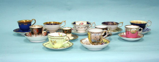 Eleven assorted handpainted cups and saucers inclu: Eleven assorted handpainted cups and saucers including an antique Old Vienna chocolate cup and saucer and 10 other English and German tea cups and saucers.