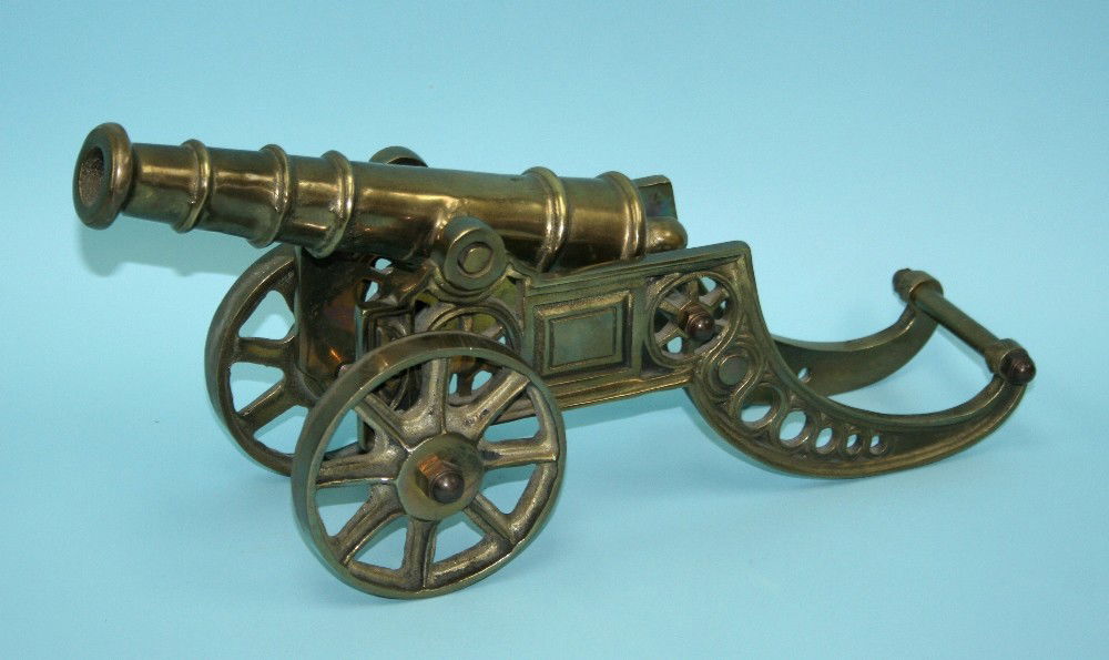 A miniature antique brass cannon resting on a Nov 16, 2011 Gallery