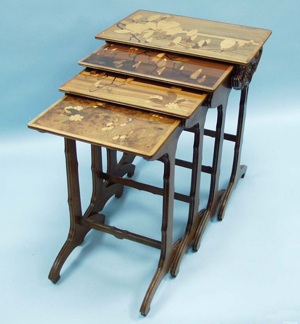 ART NOUVEAU - EMILE GALLE. A rare magnolia design m: ART NOUVEAU - EMILE GALLE. A rare magnolia design marquetry decorated four part nest-of-tables. The rectangular tops inlaid in various coloured woods with floral motives, sides surface carved in a tre