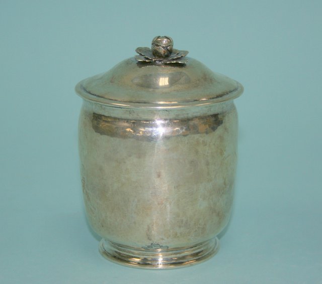 A fine antique French sterling silver covered box: A fine antique French sterling silver covered box with handhammered decoration. Lid with an applied floral ornament. Anntique hallmarks. Engraving underside bottom rim " This was made in Nancy in the