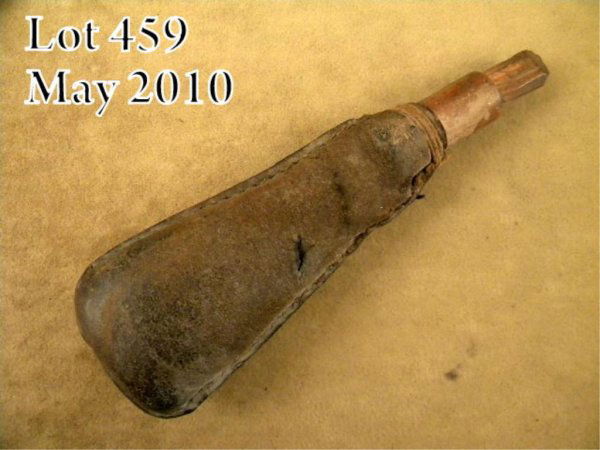 Colonial era leather and wood shot pouch, approx.: Colonial era leather and wood shot pouch, approx. 6" overall and approx. 2" wide at the base in overall good condition with a carved wood plug and filled with small shot. Est.: $50-$100.