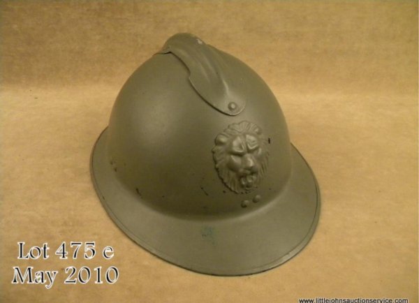 French Model 1926 military combat helmet in over: French Model 1926 military combat helmet in overall very good to excellent condition showing majority of its drab green paint; very good leather interior liner and chin strap; lion head on front with 