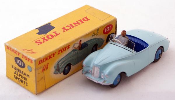 Dinky # 101 Sunbeam Alpine Sports Touring Finish. : Dinky # 101 Sunbeam Alpine Sports Touring Finish. Light Blue with Dark Blue seats, Mid Blue ridged hubs and Grey drivers. Mint in Fair tape repaired colour spot box with graffiti.