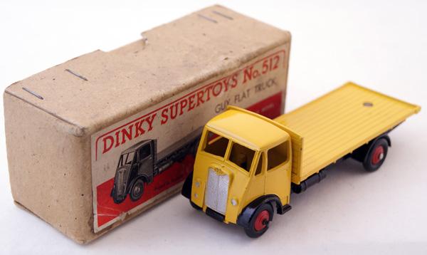 Dinky Supertoys # 512 Guy Flat Truck. Yellow with: Dinky Supertoys # 512 Guy Flat Truck. Yellow with Black chassis, small hook, Red ridged hubs. Near Mint in Excellent Buff box.