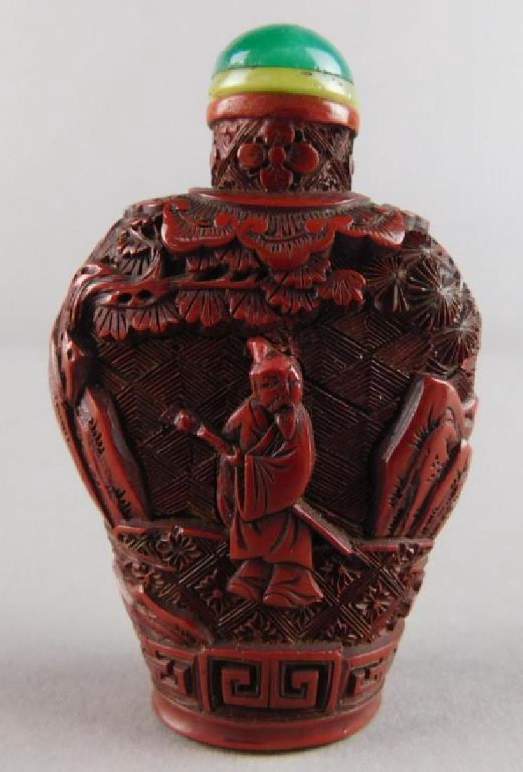Chinese Red with Green Top Snuff Bottle: Measures 2 5/8". Estimate $400 - $600. Starting bid $200.