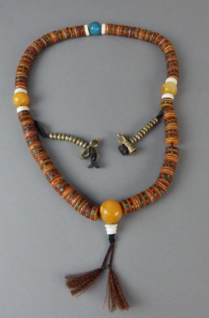 Amber, Turquoise and Ox Bone Necklace: Measures 30". Estimate $200 - $300. Starting bid $50.