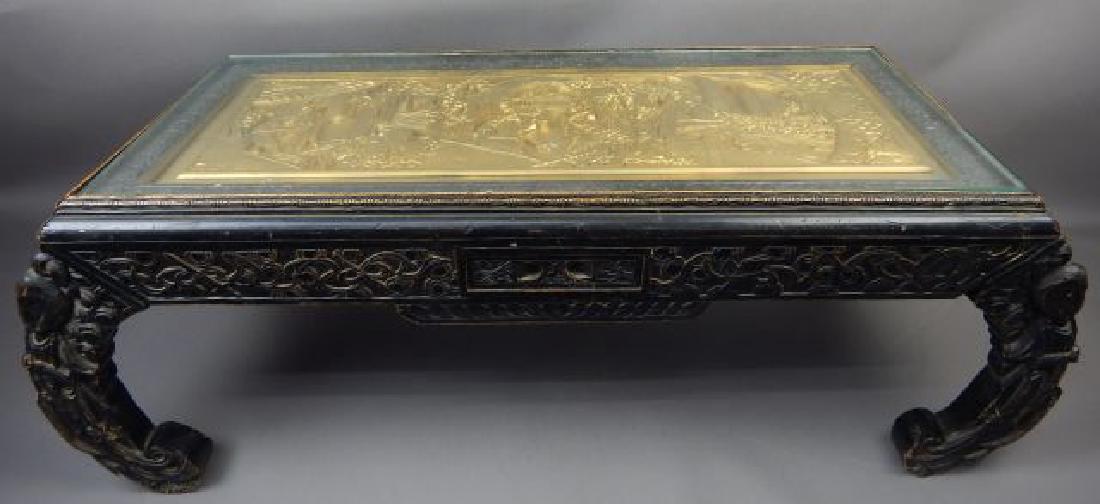 Chinese Table with Gold Carved Scene and Glass Top: Measures 14" x 38" x 15". Has a few small chips and scratches. Estimate $200 - $300. Starting bid $20.