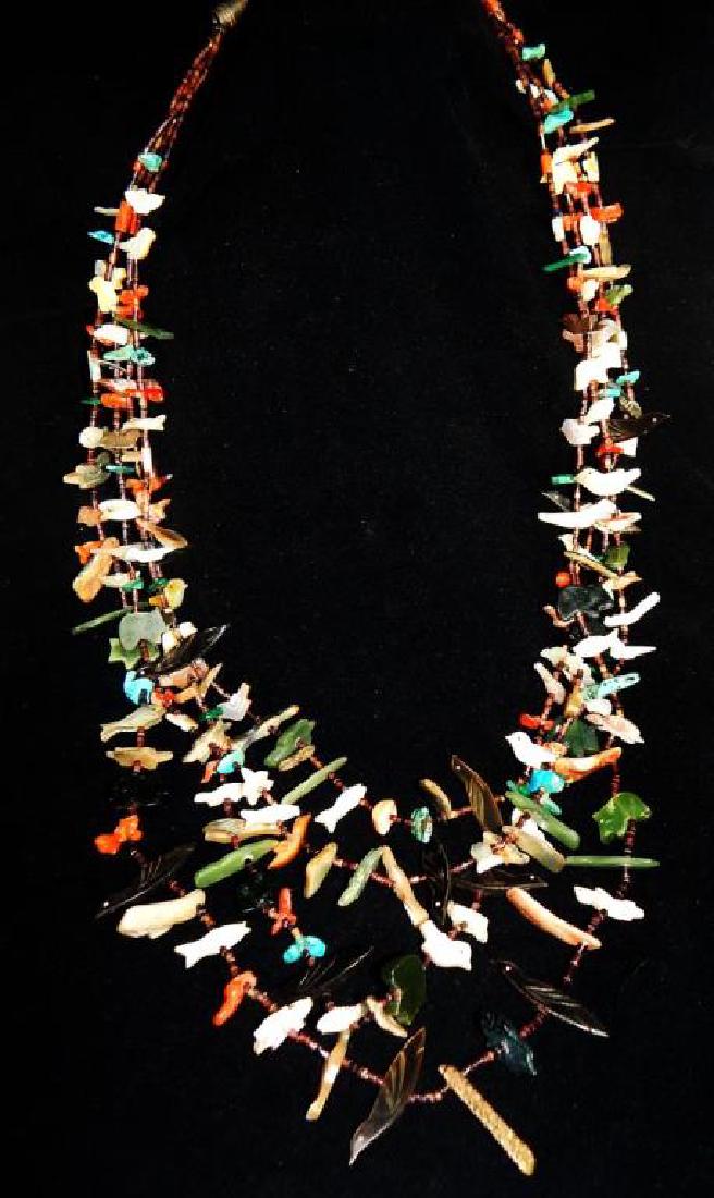 Native American Carved Fetish Necklace: Hand carved turquoise, coral, mother of pearl, bone, lapis, jade bears, birds, fish, turtles, and stone pieces. Measures 21". Estimate $200 - $400 Starting Bid $50