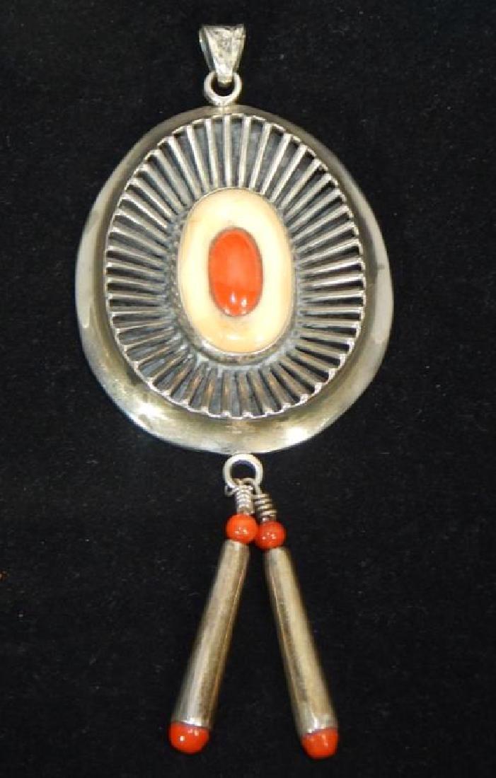 Native American Sterling Bone and Coral Pendant: Nicely done designs on sterling with bone and coral decorations. Artist signed with a symbol. Measures 5" x 2 1/4". Total weight 44.5 grams. Estimate $300 - $500 Starting Bid $30