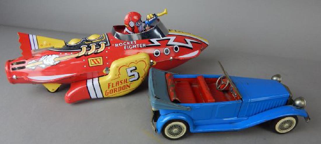 Rocket Fighter Flash Gordon & Blue Model Cars: Tin Rocket Fighter Schylling made in China, measures 12". Blue tin car made in Japan 7 1/2". Both friction. Estimate $200 - $300. Starting bid $20.