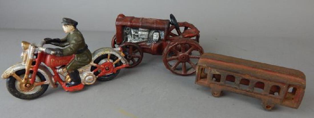 Cast Iron Tractor, Motorcycle and Train: Tractor measures 6", Patrol motorcycle 6" and Train 5". Estimate $200 - $300. Starting bid $20.