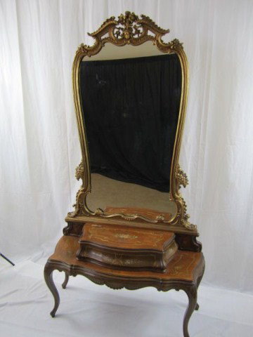 A32-64 FRENCH STYLE DRESSNG TABLE WITH MIRROR: Gold leaf mirror is surmounted with broken arch pediment with floral bouquet. Lower sides of mirror has ornate scroll designs with floral bouquet. Dresser base is executed in wood veneer with hand-pai