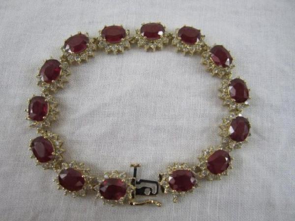 A34-2 14K YELLOW GOLD RUBY & DIAMOND BRACELET: 168 prong set round brilliant cut diamonds, measuring 1.70 - 1.50 mm (depth estimate) Clarity I-1 to I-2 Color H-J Total weight of colored stones 27.09ct. Total weight of diamonds 3.16ct. and Total we